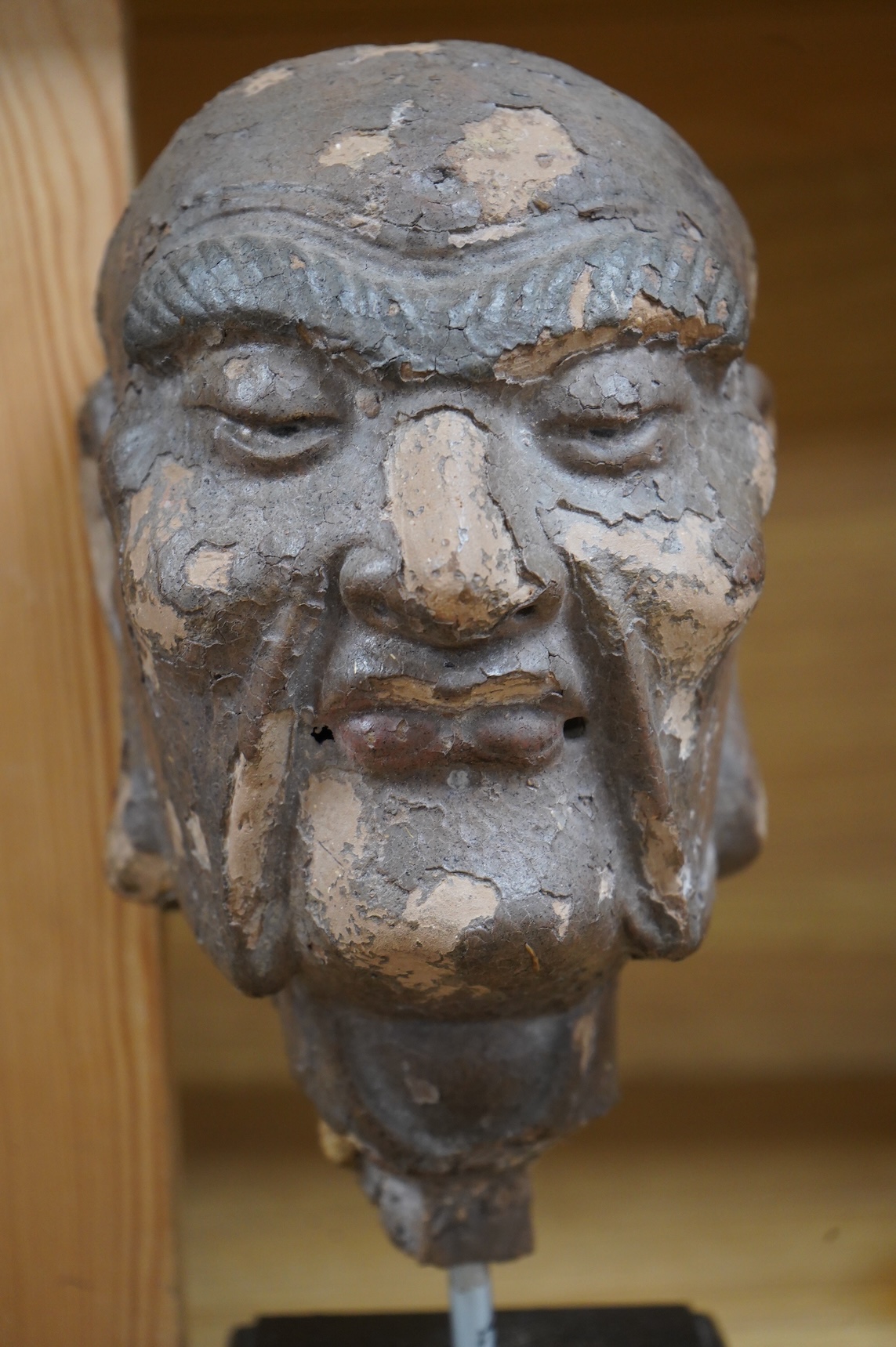 A Chinese lacquered composition head of a Luohan, early Ming, 28cm including stand